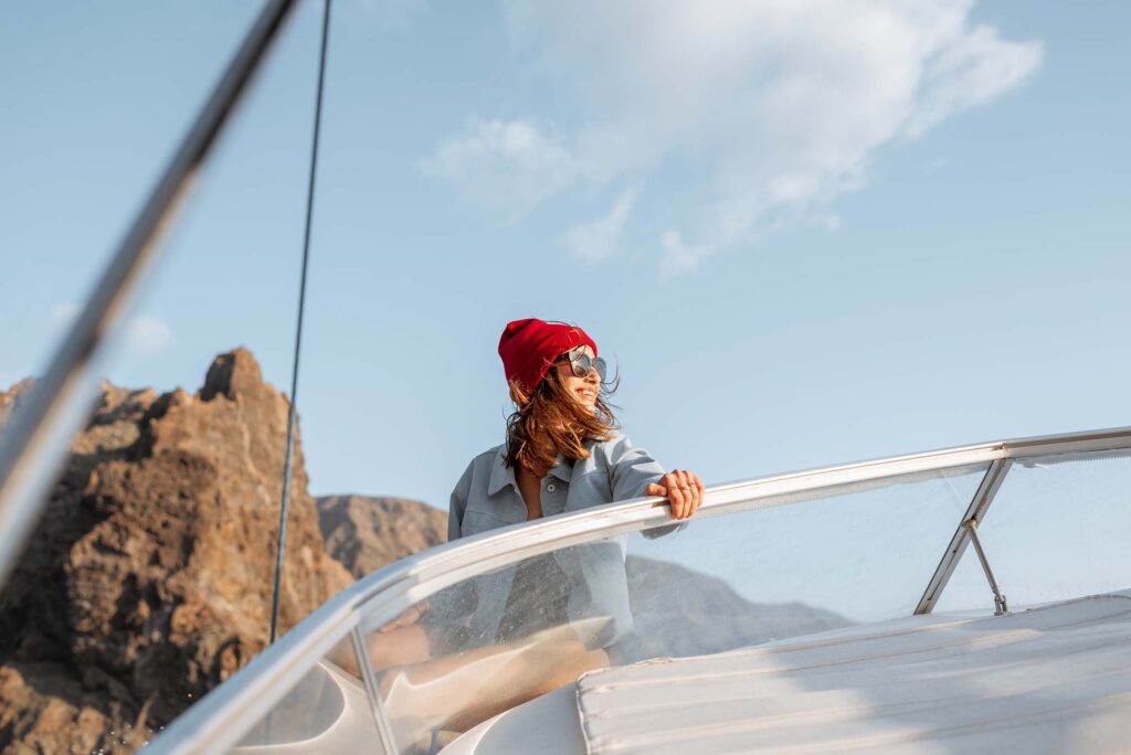 woman-sailing-on-the-yacht-near-the-rocky-coast-MESHY2A.jpg